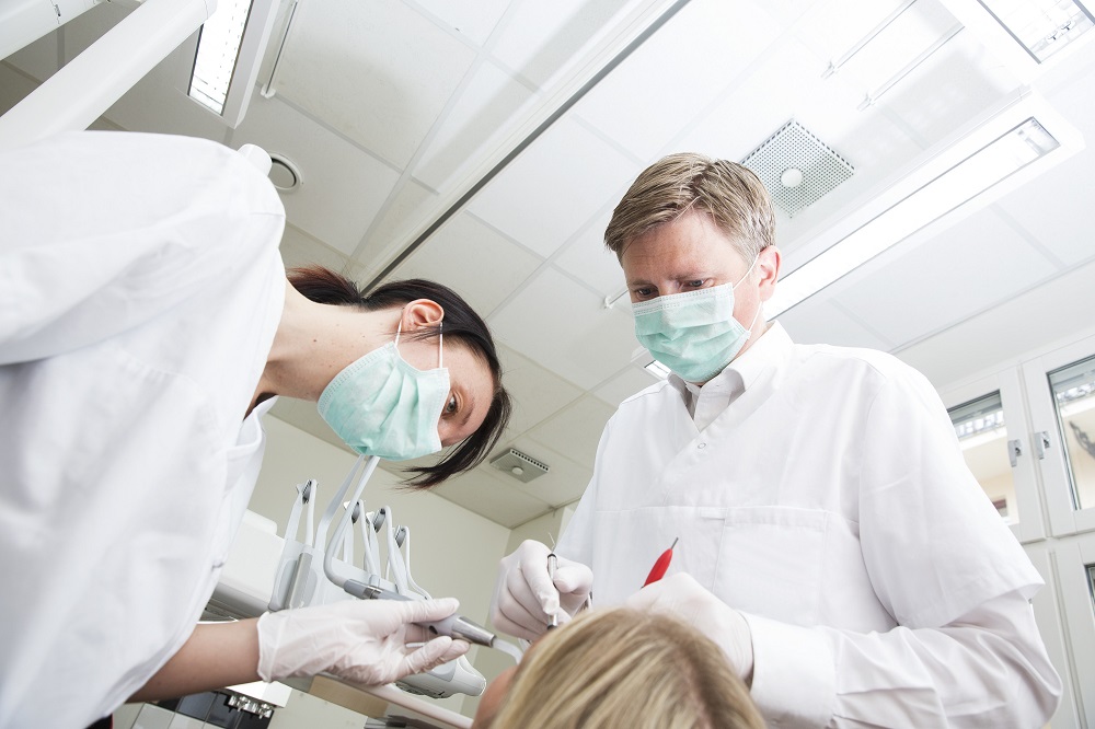 dentist performing root canal treatment